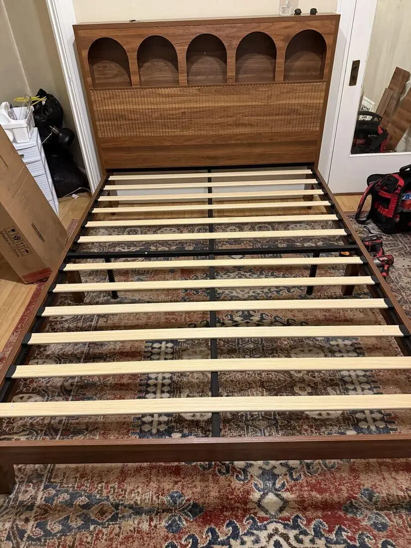 Assembled solid-wood bed frame with headboard and support slats