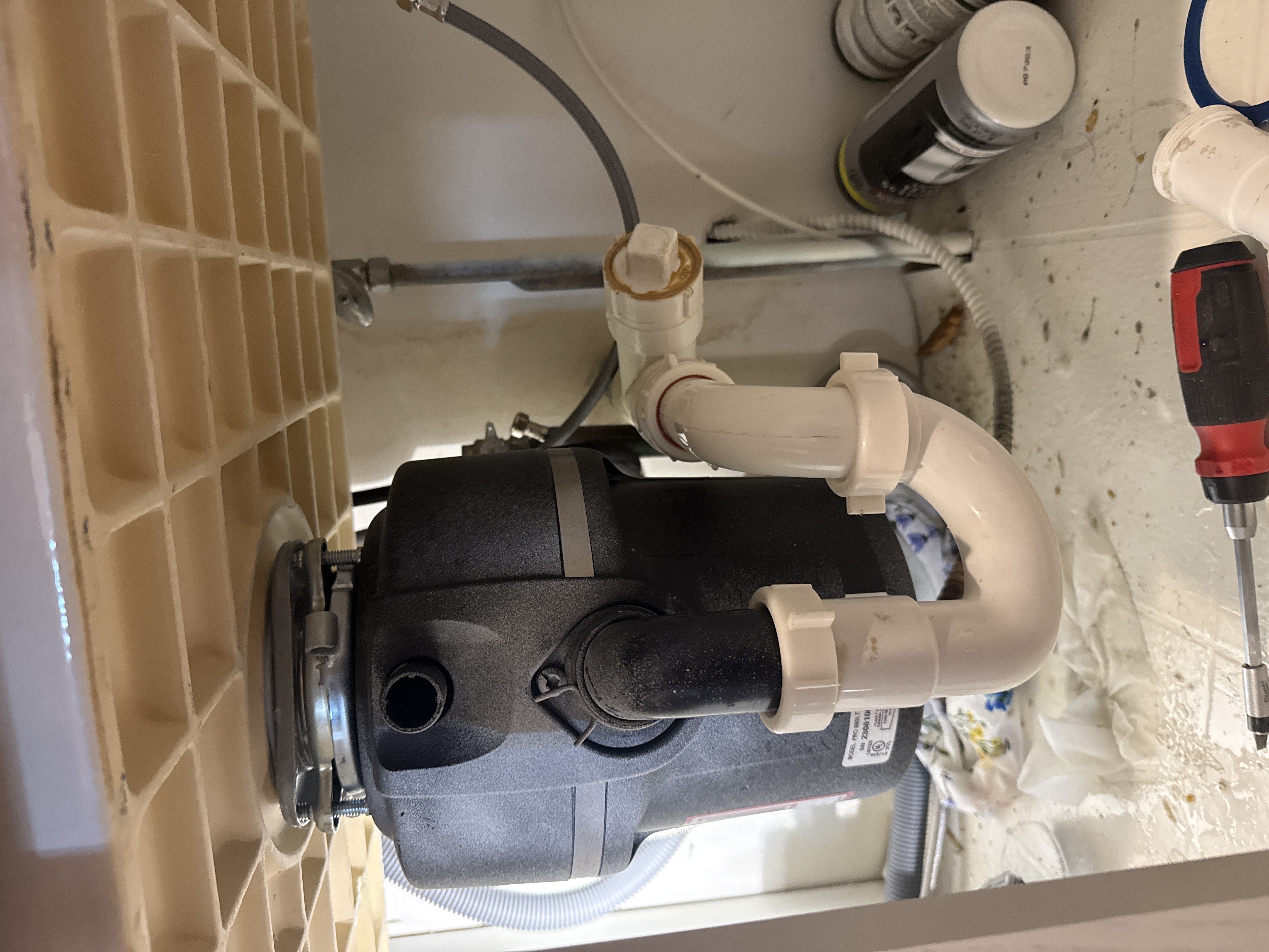 Garbage disposal unit installed under kitchen sink by North Shore Fixers Milwaukee