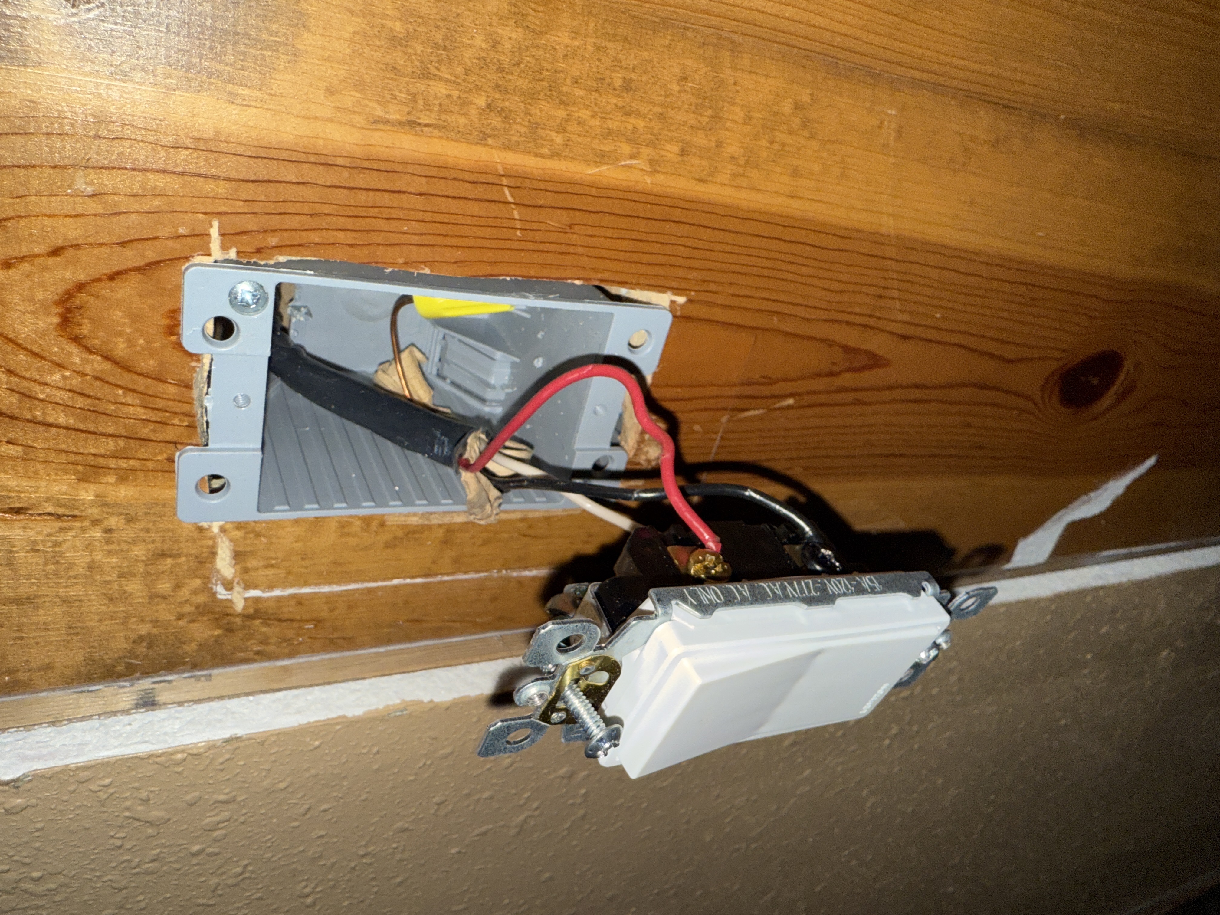 Light switch installation and wiring on wood panel wall by North Shore Fixers Milwaukee